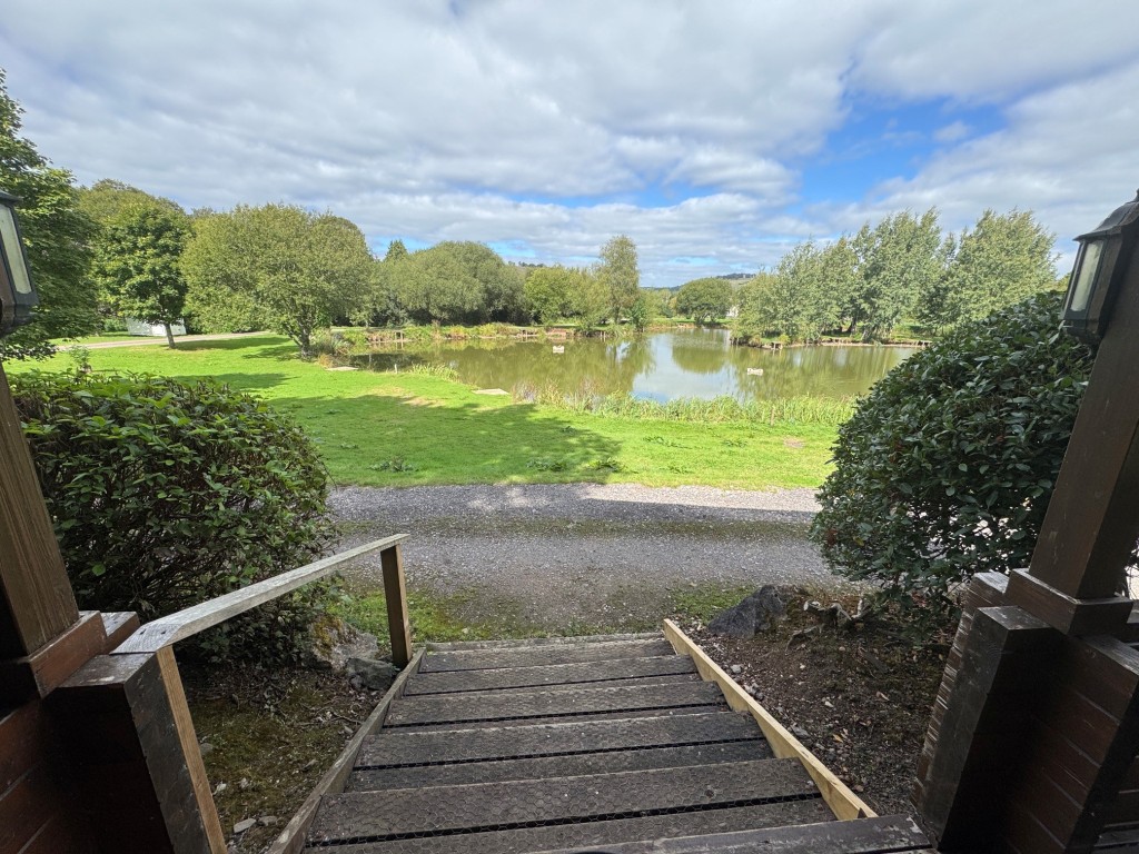 Lot: 71 - FREEHOLD TEN ACRE SITE WITH LAKES AND LODGES - Kingfisher Lodge view from veranda